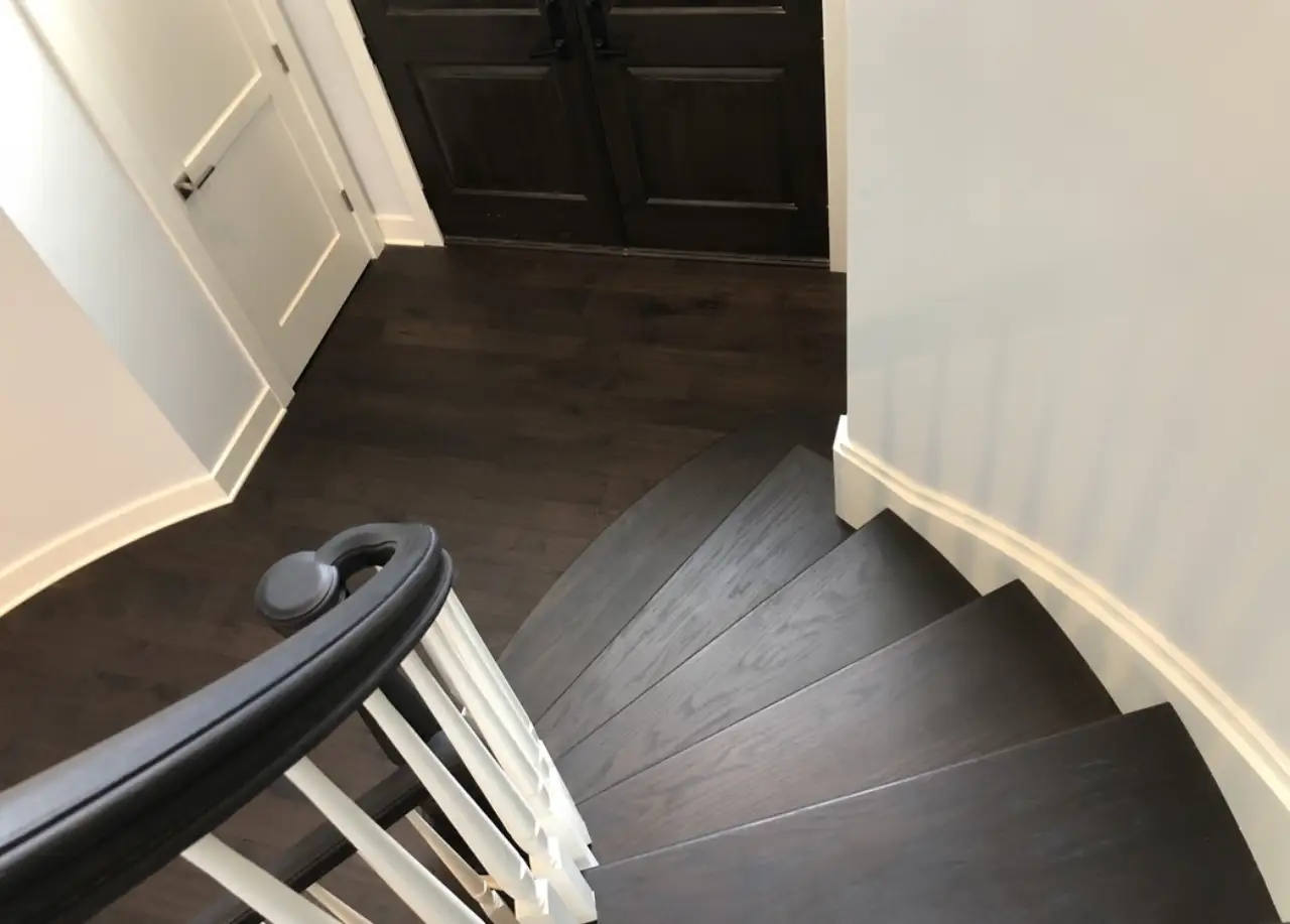 1 Wood Floors: The Authority in Species Integration Custom color-matched Red Oak staircase with hand-scraped Dusky Walnut flooring — eye-level view walking down — 1 Wood Floors Michigan