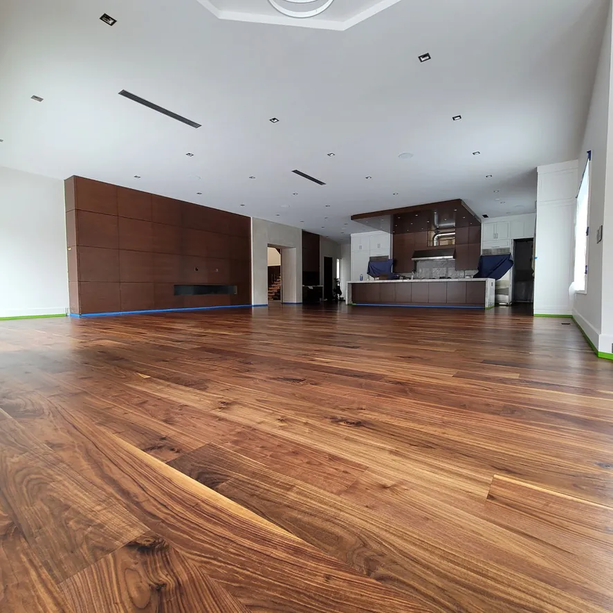 Custom 8-inch FAS Walnut engineered flooring and matching floating staircase in Northville, MI by 1 Wood Floors