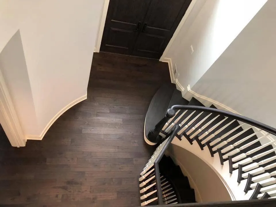 Bird's-eye view from catwalk of custom Red Oak staircase renovation matching Dusky Walnut flooring — Farmington Hills MI — 1 Wood Floors